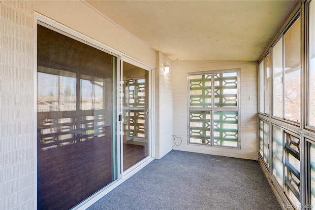 unfurnished sunroom with vaulted ceiling