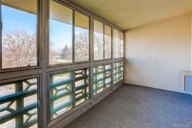 unfurnished sunroom with lofted ceiling