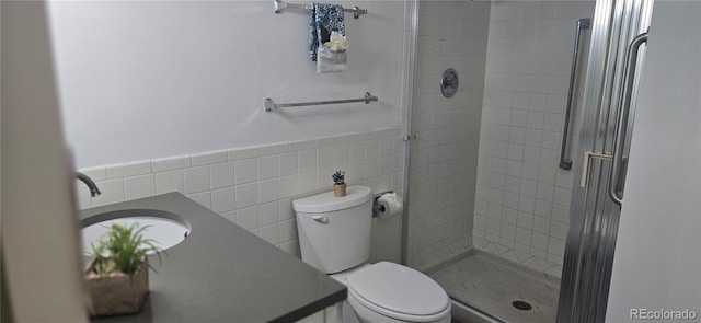 755 S Alton Way Unit 9D, Denver, CO 80247 - bathroom with a stall shower, vanity, tile walls, and a wainscoted wall
