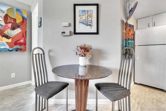 dining space with light wood-type flooring