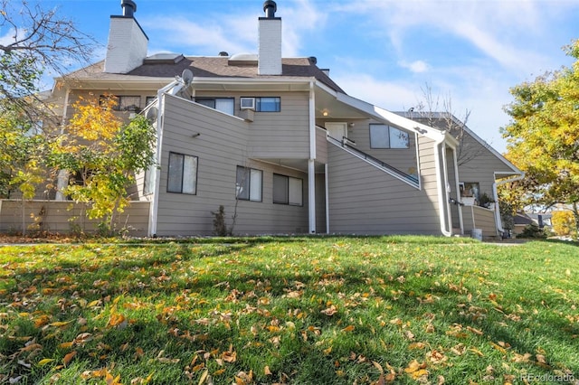 back of house with a lawn