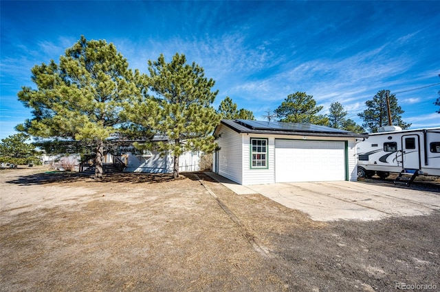 view of front facade with a garage and solar panels