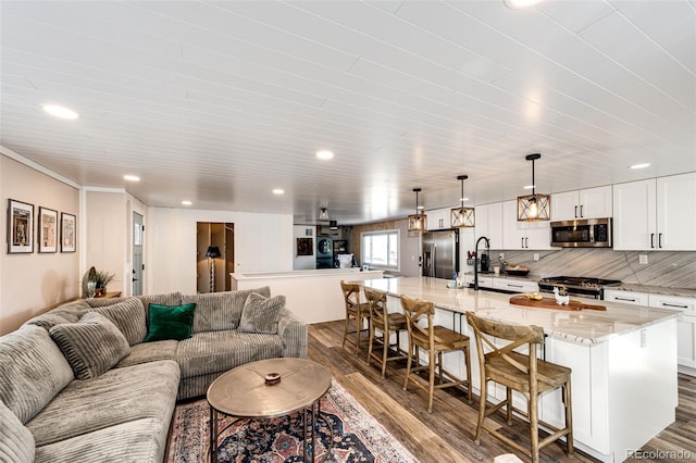 living area with dark wood-style floors and recessed lighting