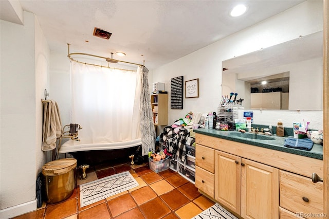 bathroom featuring tile patterned floors, shower / bathtub combination with curtain, and vanity