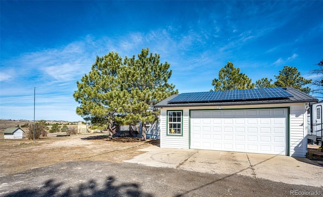 detached garage with roof mounted solar panels