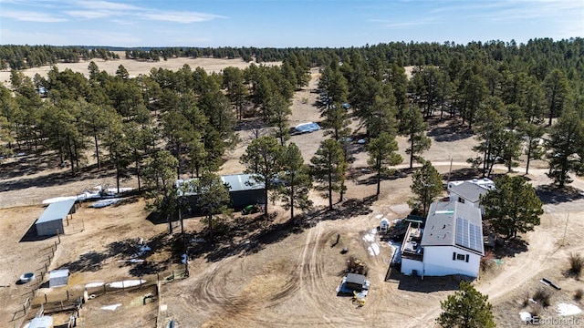 drone / aerial view featuring a view of trees