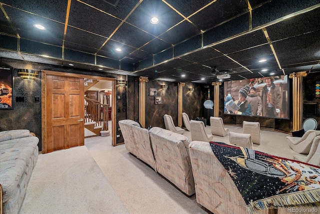 home theater with a drop ceiling, light carpet, and decorative columns