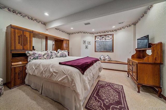 carpeted bedroom featuring beam ceiling