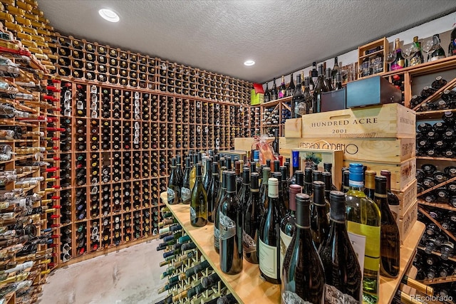 wine cellar with concrete floors and a textured ceiling