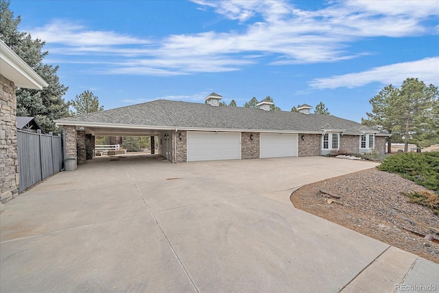 view of front of house featuring a garage and a carport