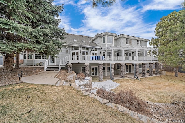 back of house with a patio area, a deck, and a lawn