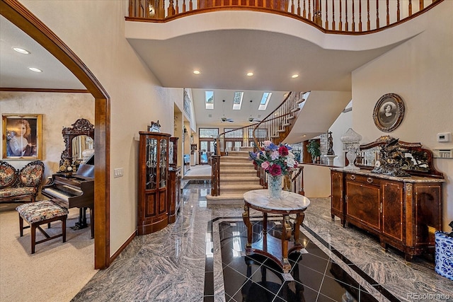 entryway with dark tile flooring and a high ceiling