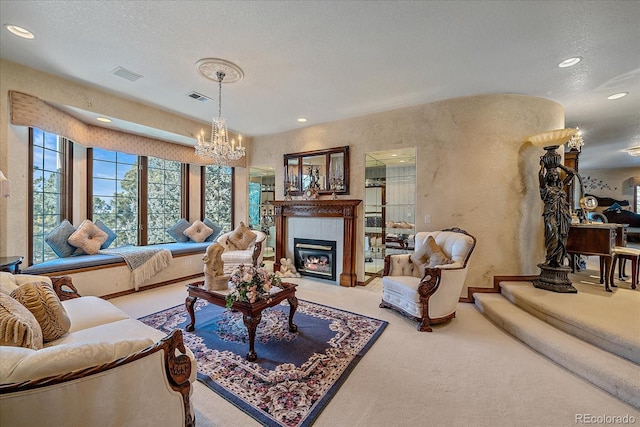 living room with an inviting chandelier, light carpet, a fireplace, and a textured ceiling