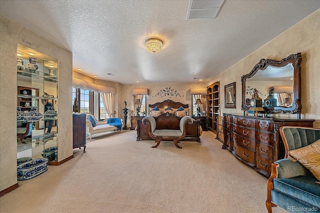 living area with light colored carpet and a textured ceiling