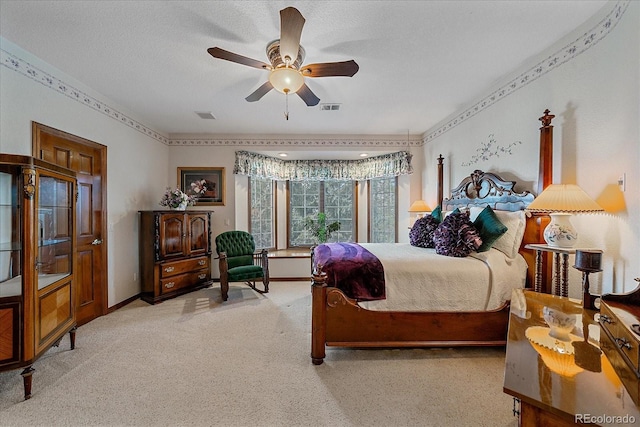 carpeted bedroom featuring ceiling fan and a textured ceiling