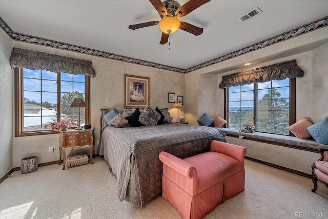 bedroom with ceiling fan and light colored carpet