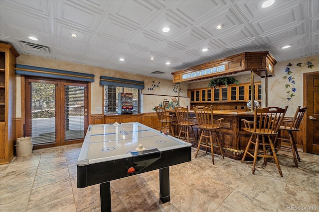 game room with light tile flooring and bar