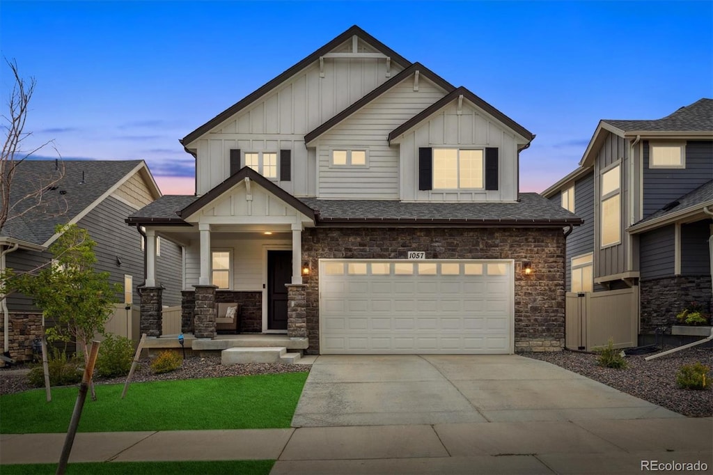 craftsman-style house featuring a lawn and a garage