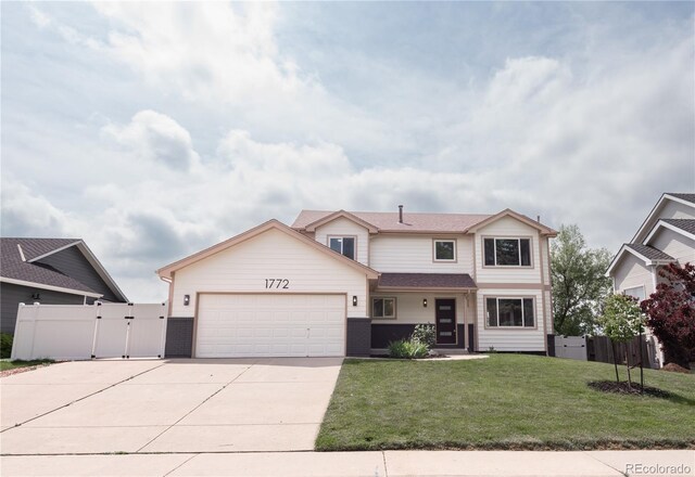 1772 Eisenhower, Louisville, CO 80027 - traditional-style home with a gate, driveway, an attached garage, and brick siding