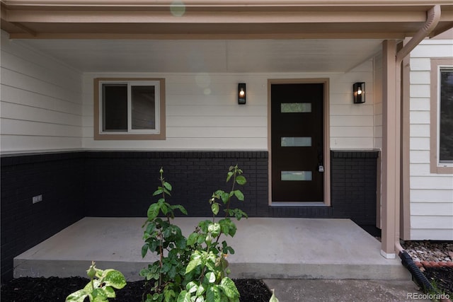 1772 Eisenhower, Louisville, CO 80027 - property entrance featuring covered porch and brick siding
