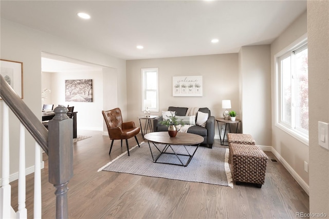 1772 Eisenhower, Louisville, CO 80027 - living area with wood finished floors, plenty of natural light, recessed lighting, baseboards, and stairs