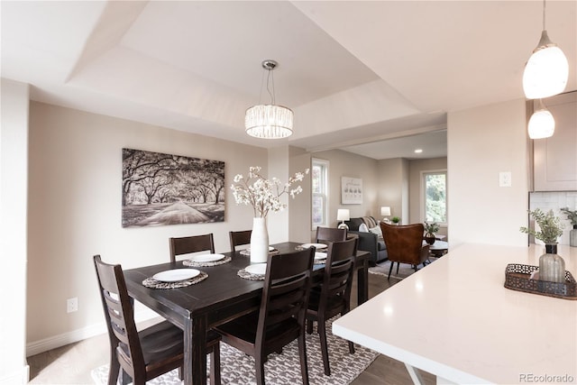 1772 Eisenhower, Louisville, CO 80027 - dining area with a chandelier, a tray ceiling, light wood-type flooring, and baseboards