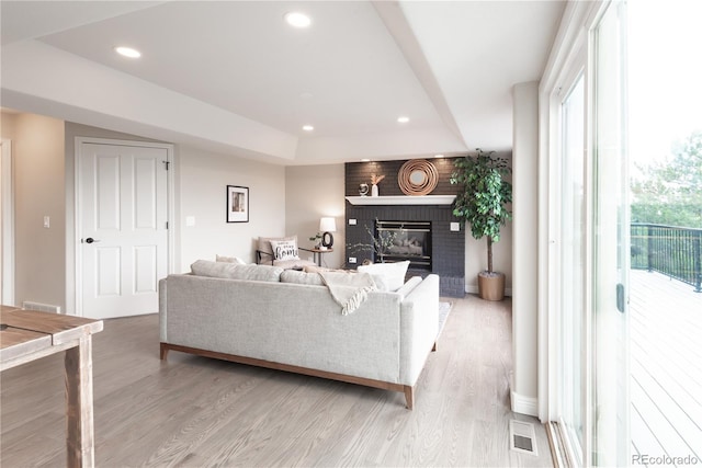 1772 Eisenhower, Louisville, CO 80027 - living room with light wood finished floors, recessed lighting, a brick fireplace, and a raised ceiling