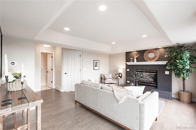 1772 Eisenhower, Louisville, CO 80027 - living area with a tray ceiling, baseboards, wood finished floors, a brick fireplace, and recessed lighting