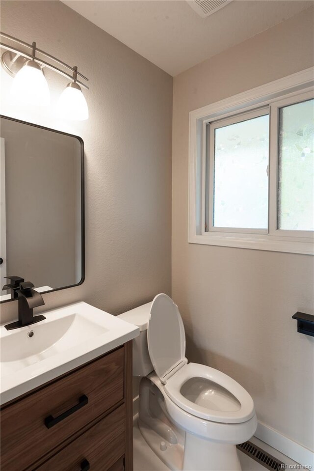 1772 Eisenhower, Louisville, CO 80027 - half bathroom with toilet, vanity, and baseboards