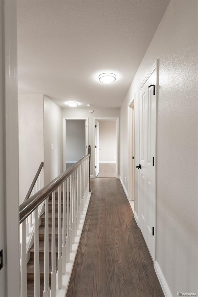 1772 Eisenhower, Louisville, CO 80027 - hall with dark wood finished floors, baseboards, and an upstairs landing