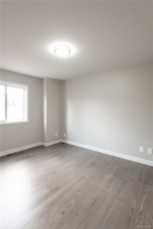 1772 Eisenhower, Louisville, CO 80027 - unfurnished room with dark wood-style floors, baseboards, and a textured ceiling