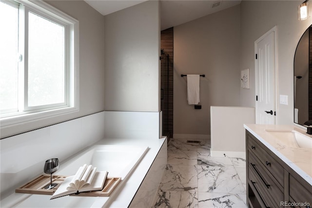 1772 Eisenhower, Louisville, CO 80027 - bathroom featuring vanity, a bath, marble finish floors, and baseboards