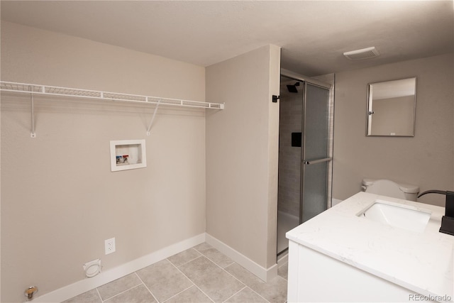 1772 Eisenhower, Louisville, CO 80027 - laundry area with hookup for a washing machine, baseboards, and light tile patterned floors