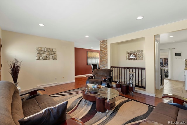 living area featuring baseboard heating, recessed lighting, baseboards, and wood finished floors