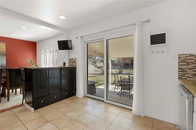 doorway with light tile patterned floors, visible vents, recessed lighting, and baseboards