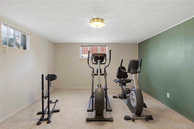 workout room with baseboards, a textured ceiling, and carpet flooring