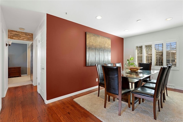 dining space with recessed lighting, wood finished floors, and baseboards