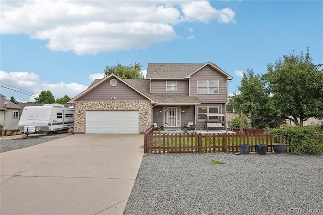 7667 W Brook Dr, Littleton, CO 80128 - traditional home with concrete driveway, an attached garage, a fenced front yard, stone siding, and roof with shingles