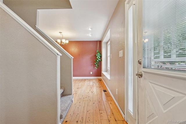 7667 W Brook Dr, Littleton, CO 80128 - entryway featuring light wood finished floors and a chandelier