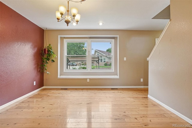 7667 W Brook Dr, Littleton, CO 80128 - unfurnished dining area with a chandelier and light wood-style floors