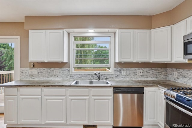 7667 W Brook Dr, Littleton, CO 80128 - kitchen featuring stainless steel appliances, white cabinetry, decorative backsplash, and light countertops