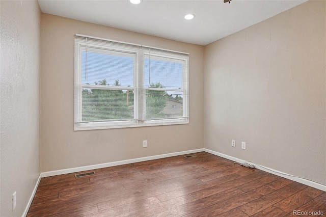7667 W Brook Dr, Littleton, CO 80128 - empty room featuring plenty of natural light, wood-type flooring, and recessed lighting