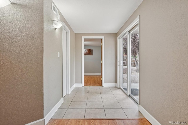 7667 W Brook Dr, Littleton, CO 80128 - hallway with a textured wall and light tile patterned floors