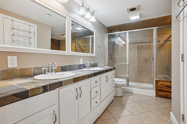 7667 W Brook Dr, Littleton, CO 80128 - full bath featuring double vanity, a shower stall, and tile patterned floors
