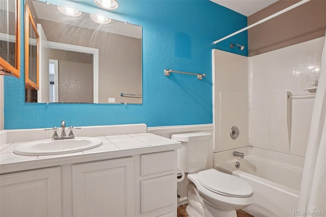 7667 W Brook Dr, Littleton, CO 80128 - full bathroom with vanity, wainscoting, shower / bath combination, and a textured wall