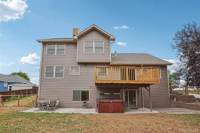 7667 W Brook Dr, Littleton, CO 80128 - back of house with a hot tub, a patio, a wooden deck, a fenced backyard, and a chimney