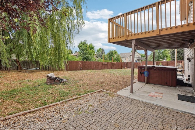 7667 W Brook Dr, Littleton, CO 80128 - fenced backyard with a hot tub, a patio area, and a wooden deck