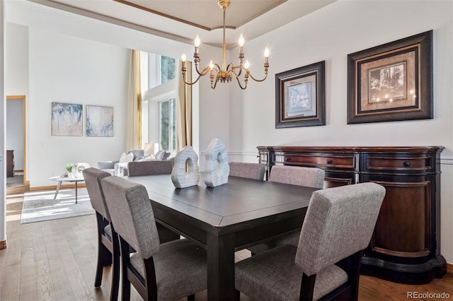 dining area featuring a chandelier and wood-type flooring