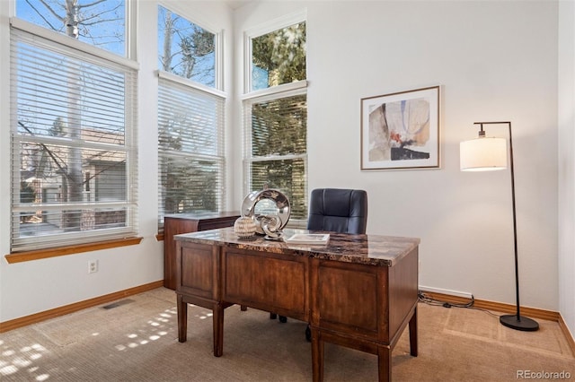 office with light carpet, baseboards, and visible vents