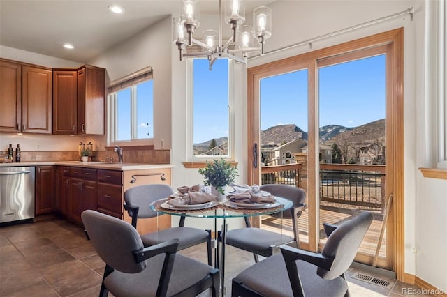 dining space featuring dark tile patterned floors, visible vents, a chandelier, and recessed lighting